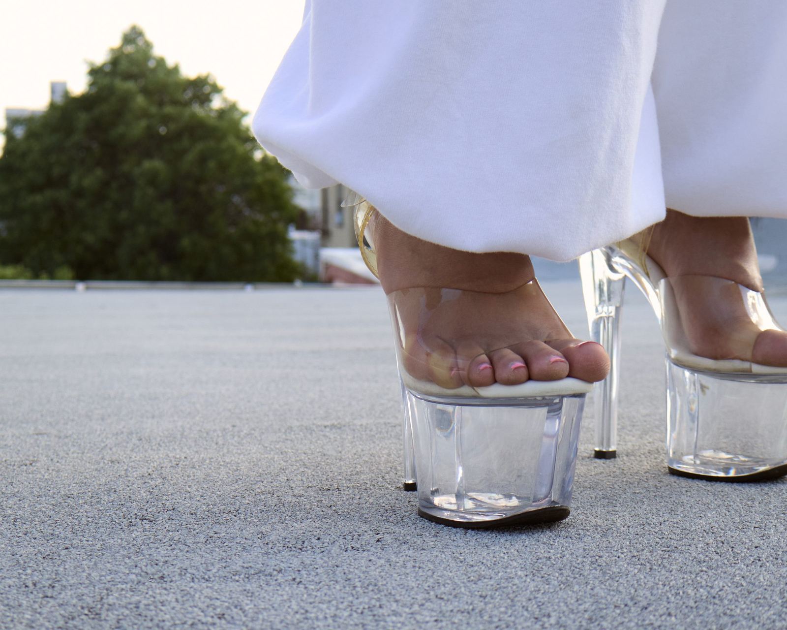 Clear platform heels on the rooftop at dusk